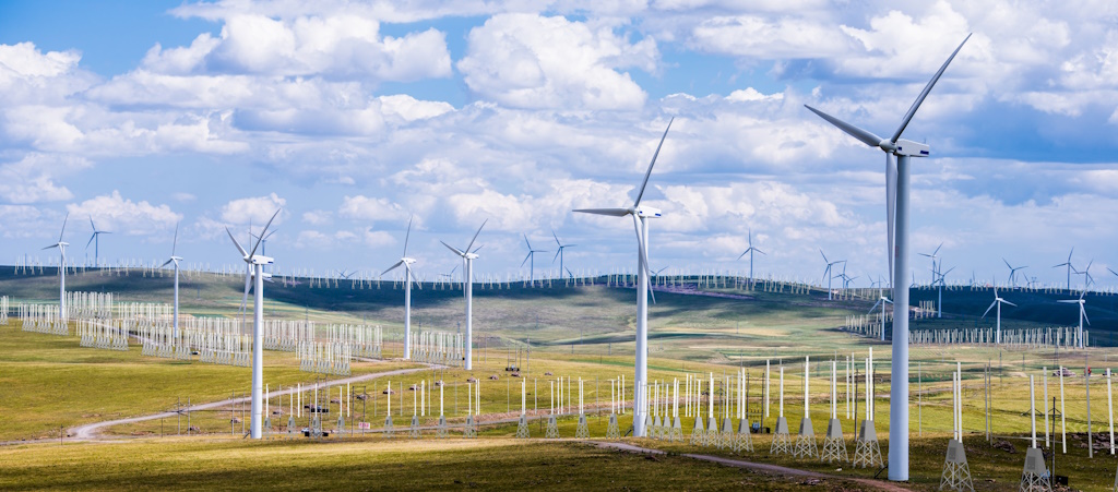 An open field wind farm with wind harvesters.